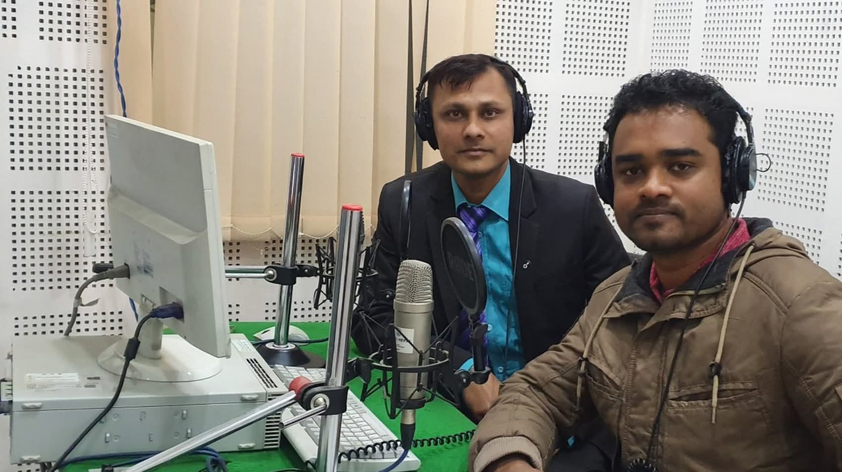 Fakrul Islam producing a radio programme with a colleague in a Nepali community radio studio